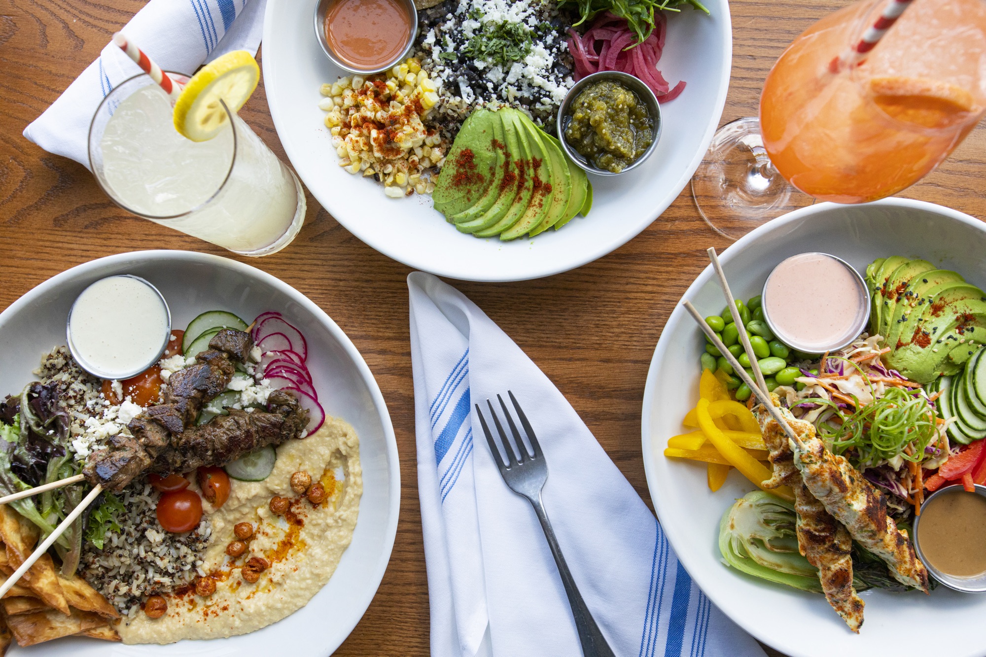 Variety of plated dishes and beverages on a wood table